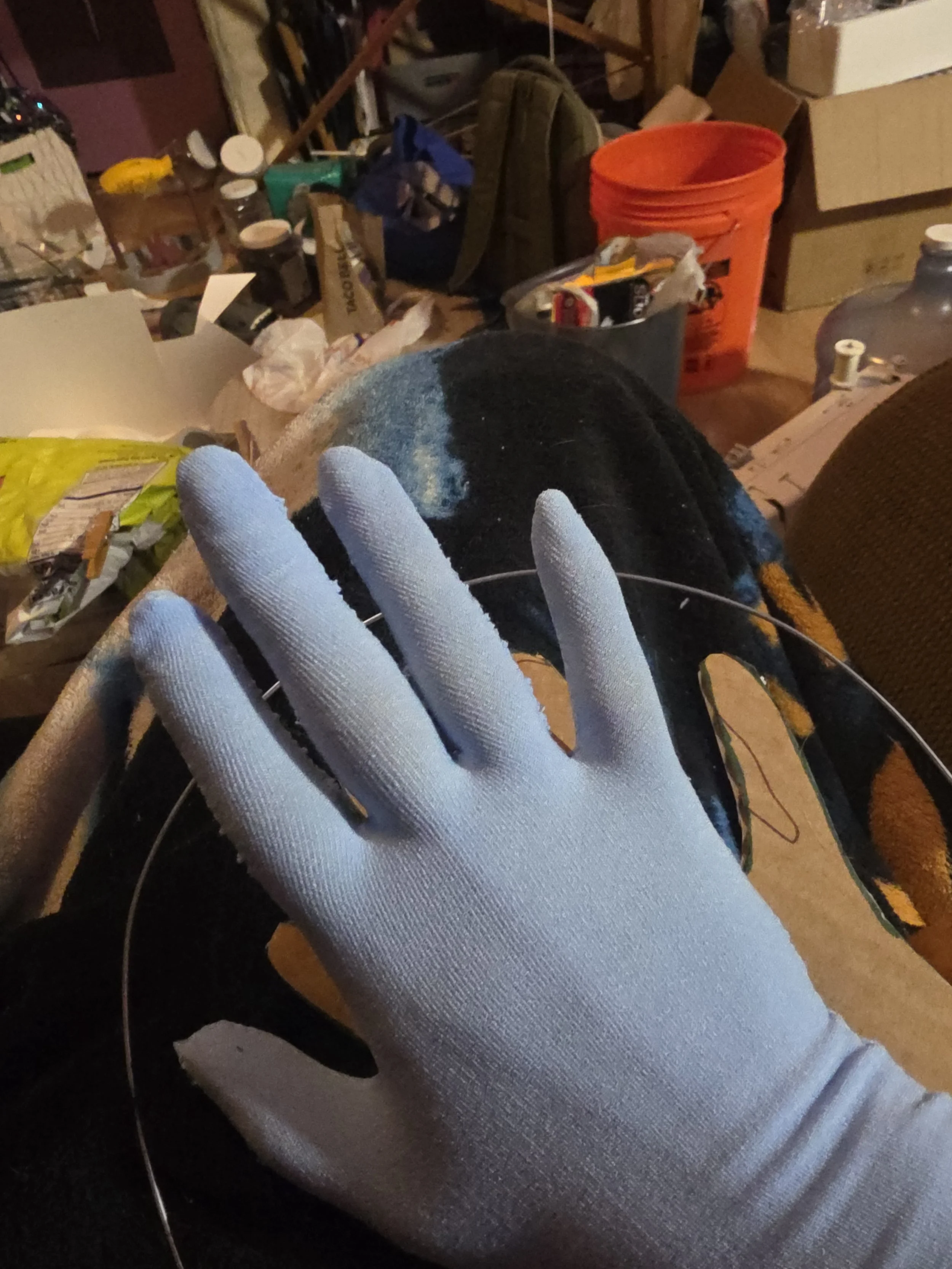 hand in a glove made of pale blue tights. It has a smooth, snug fit