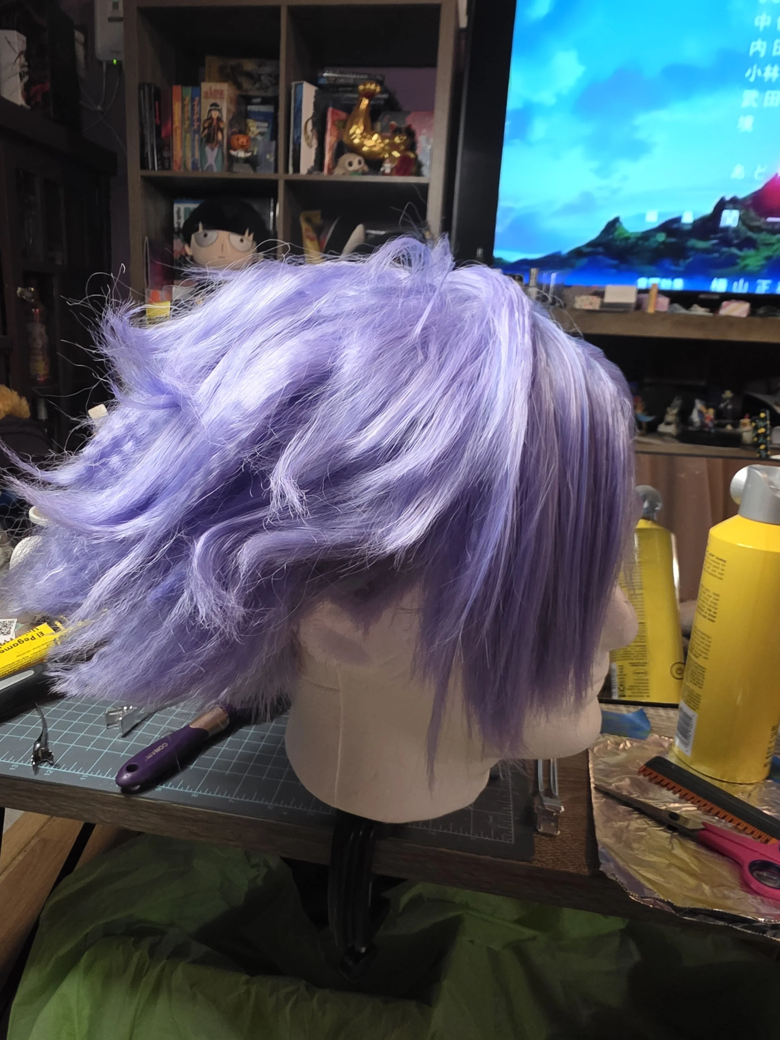 side view of a short lavender wig with long bangs combed over one eye. the back is spiked outwards