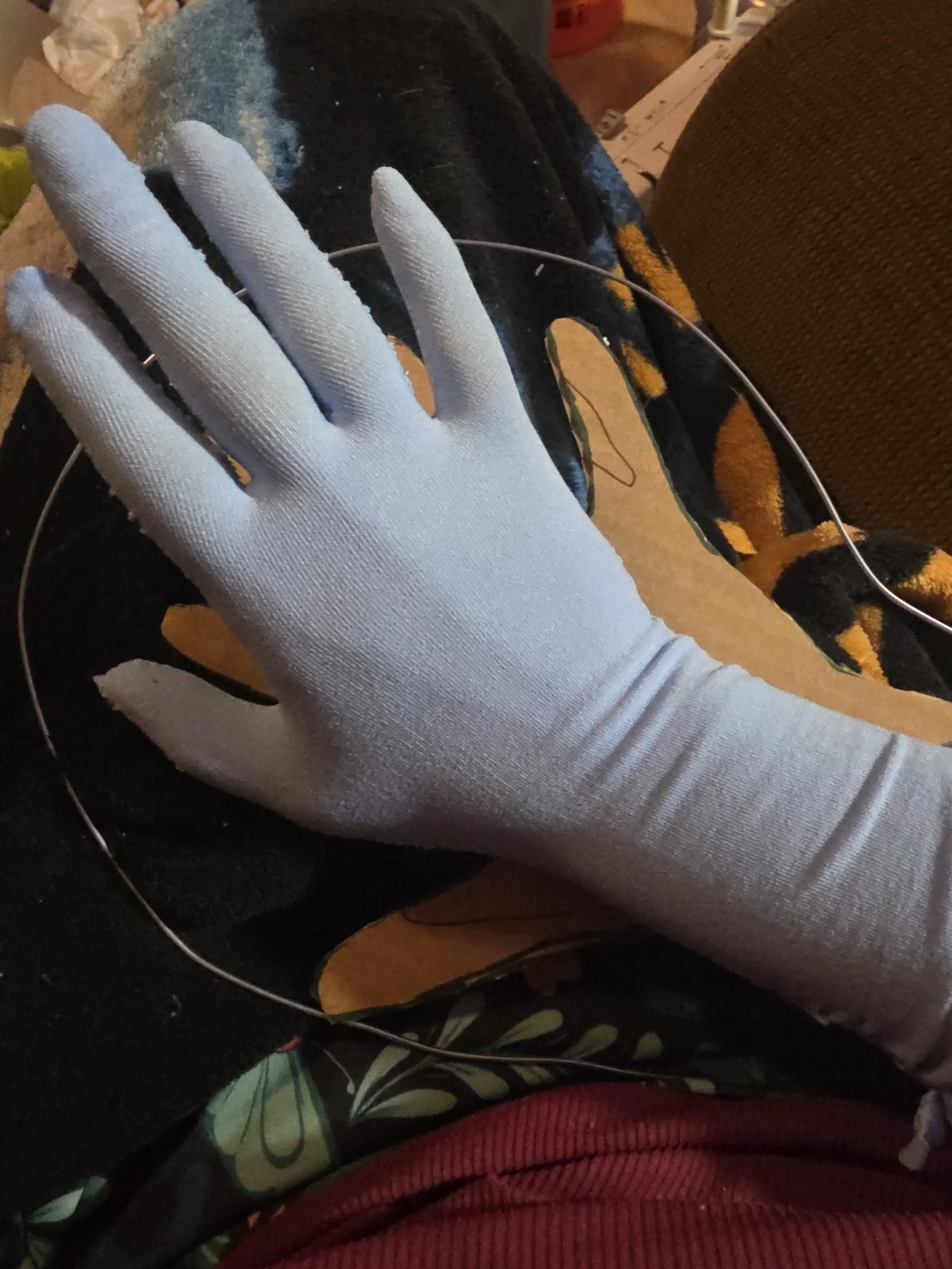 hand in a glove made of pale blue tights. It has a smooth, snug fit