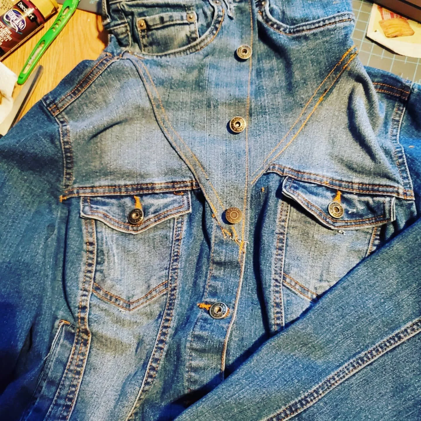 completed denim sewing project where the top of some children's jeans are sewn onto the the top of a denim shirt to give it an absurdly high collar.