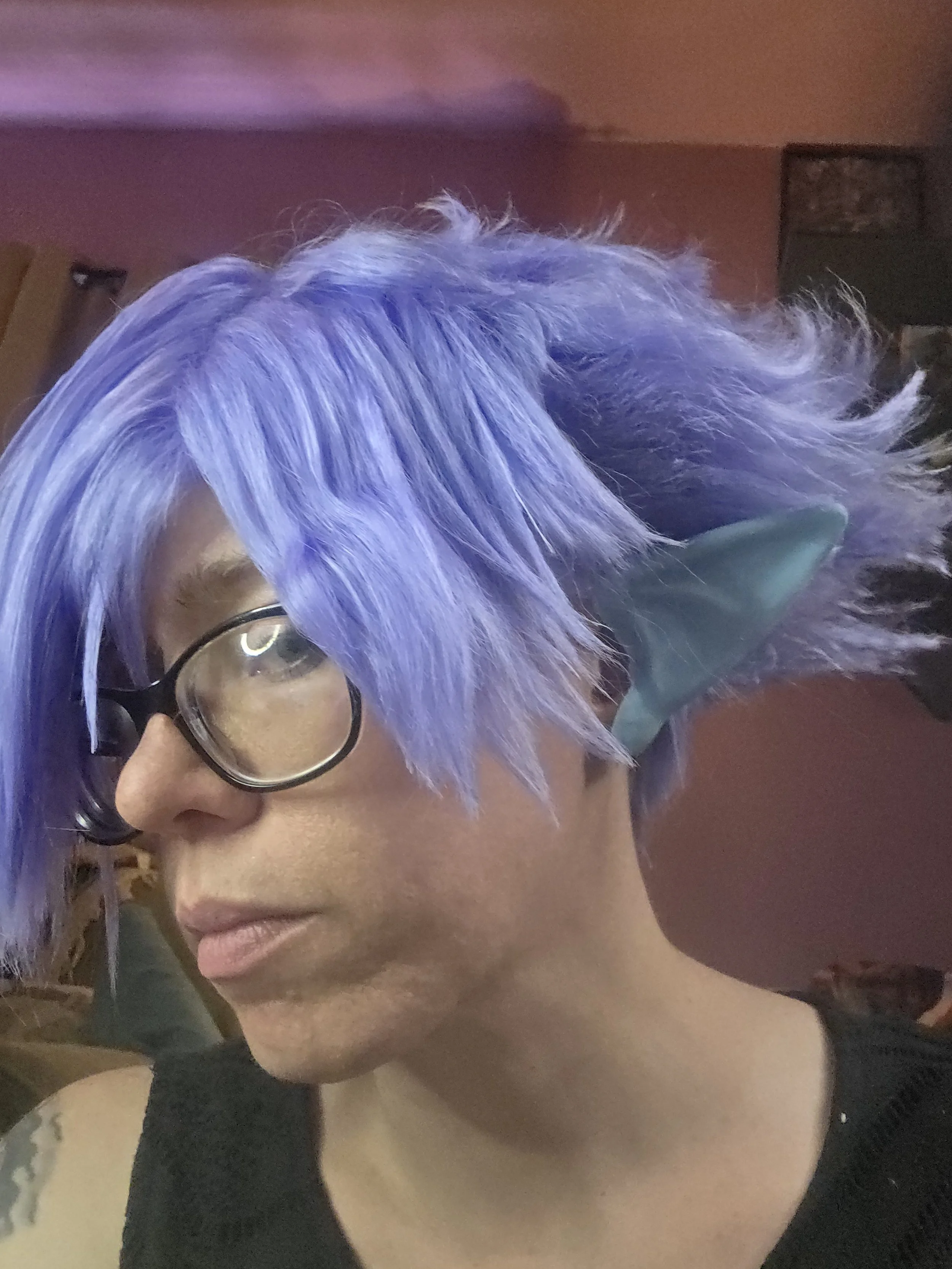 cosplayer wearing a lavender wig and pale blue pointy ears