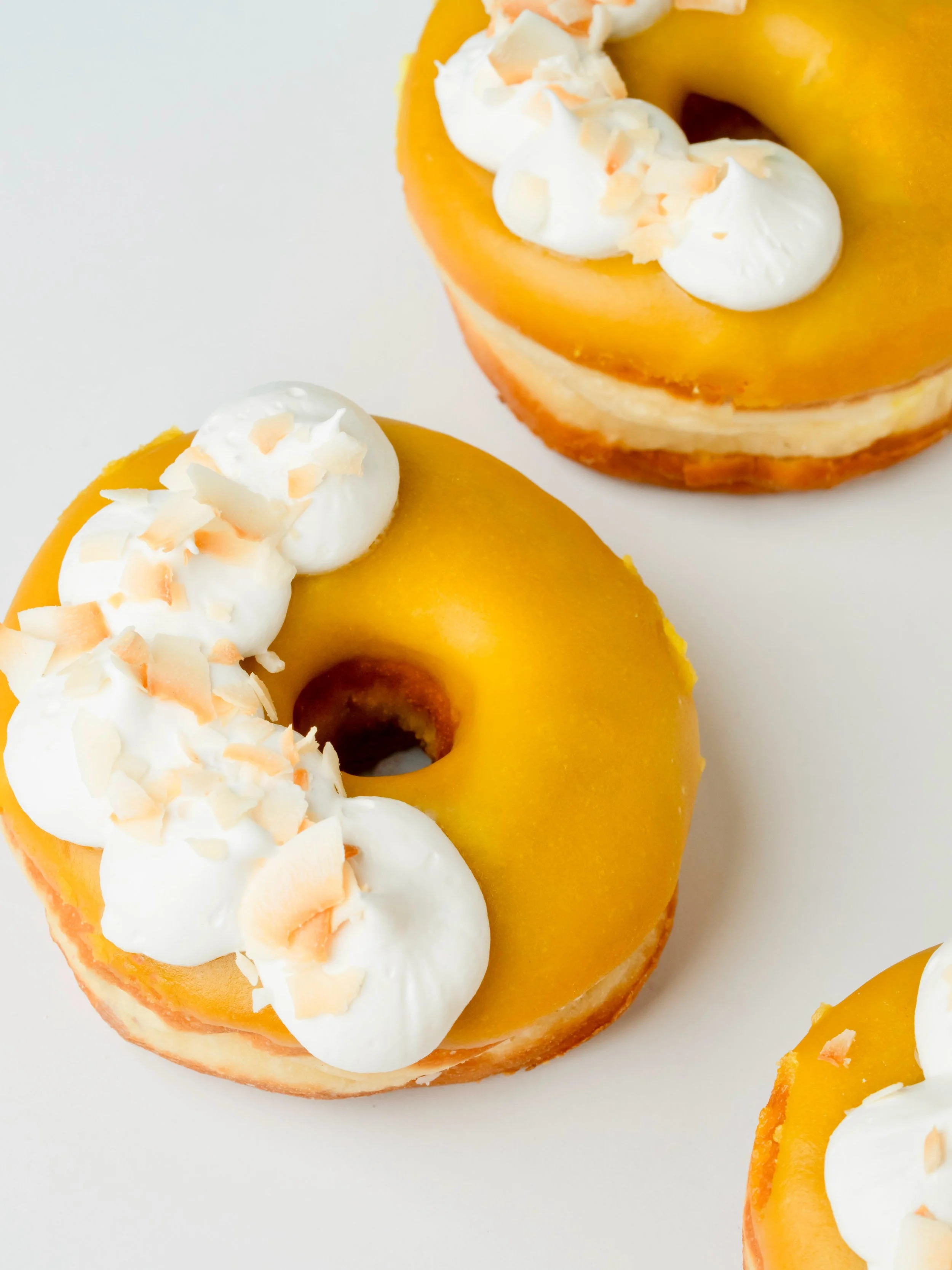 A little tropical detour, no plane ticket required. ✈️🌴

Our new Passionfruit Coconut donut is filled with coconut cream, dipped in tangy passionfruit icing, and topped with marshmallow fluff and coconut flakes. 🥥🌺

It&rsquo;s one of several new d