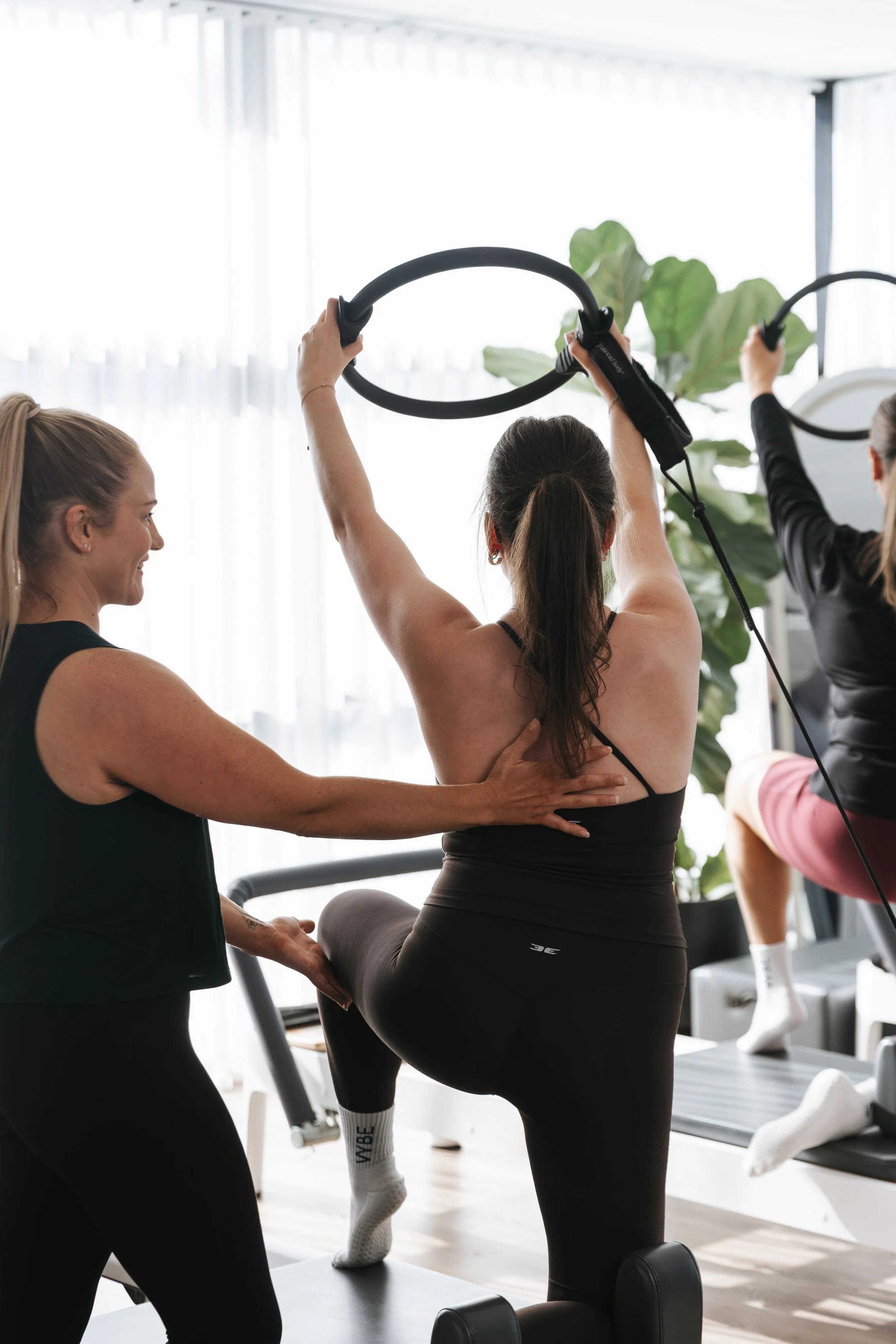 Vybe Movement trainer providing movement coaching during an upper body exercise at their Cranbourne studio