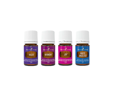 Four small bottles of Young Living essential oils labeled Valor, Harmony, Joy, and White Angelica.