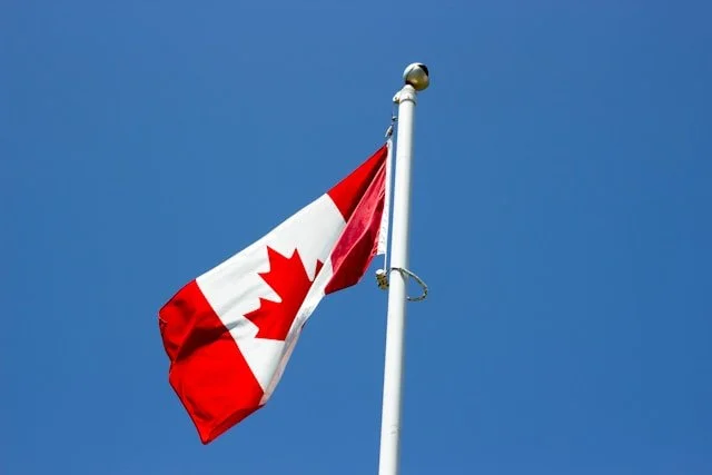 Canadian flag on pole – trusted immigration lawyers in Canada helping families build a future