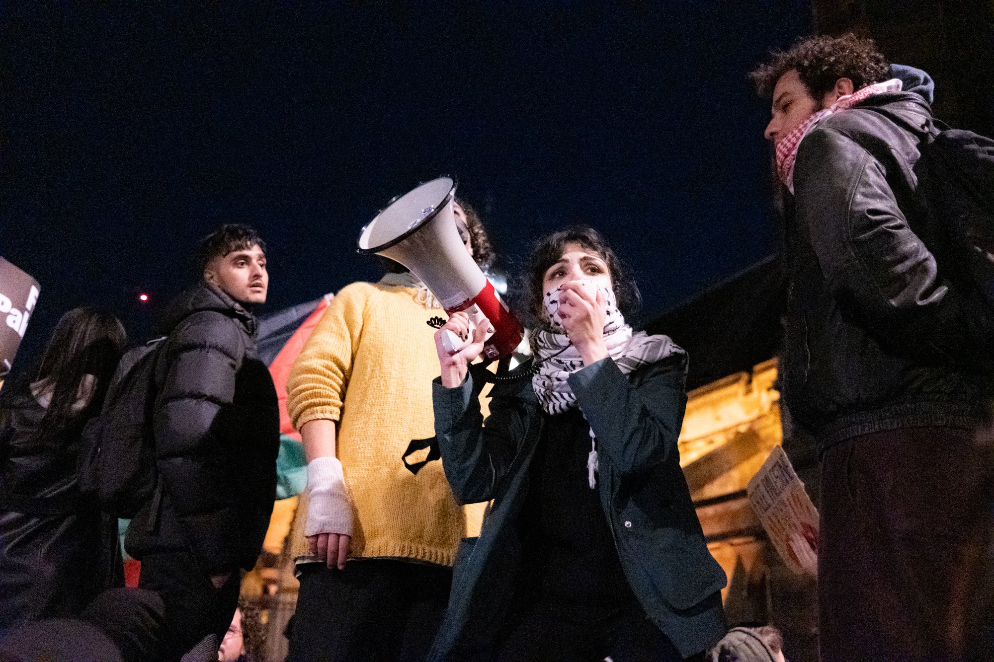 A woman speaks through a megaphone to a crowd of pro-Palestine protesters outside the Houses of Parliament as MPs gathered to vote on a motion calling for a ceasefire in Gaza - November 15, 2023