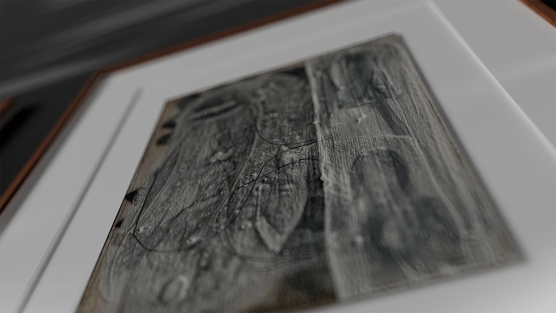 A framed black and white photograph of a forest scene with trees and their reflections in water.