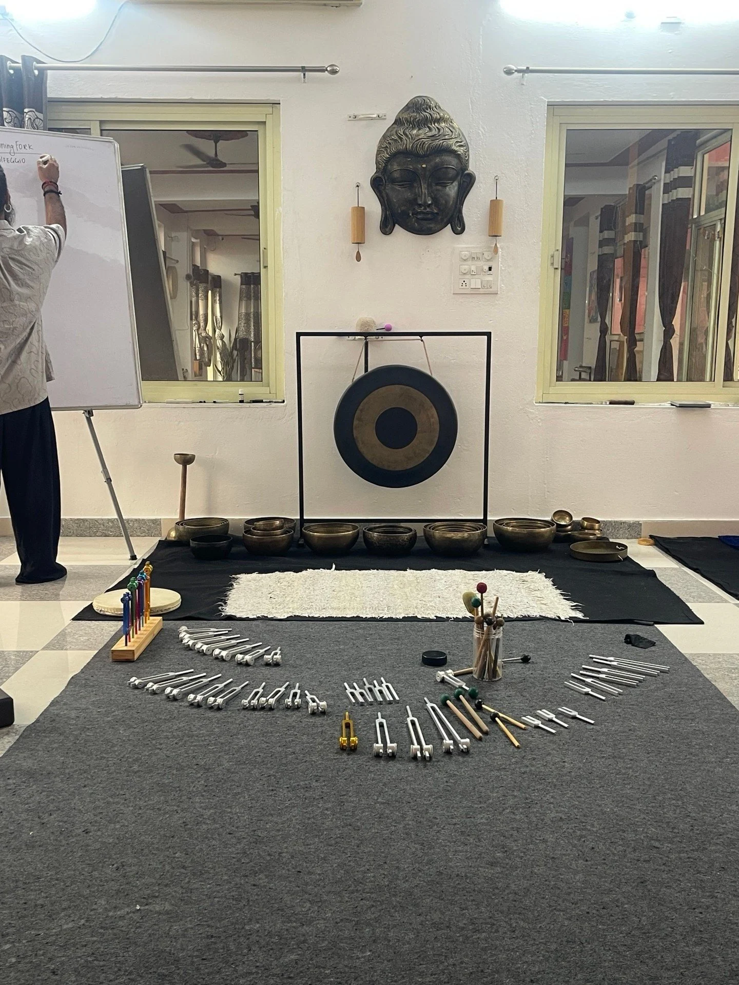 This is what the work actually looks like &mdash; not a metaphor, an actual weight.

A singing bowl set directly on the chest. A tuning fork walked slowly down the arch of a foot. No talking. The sound does what it does, and the body just... listens.