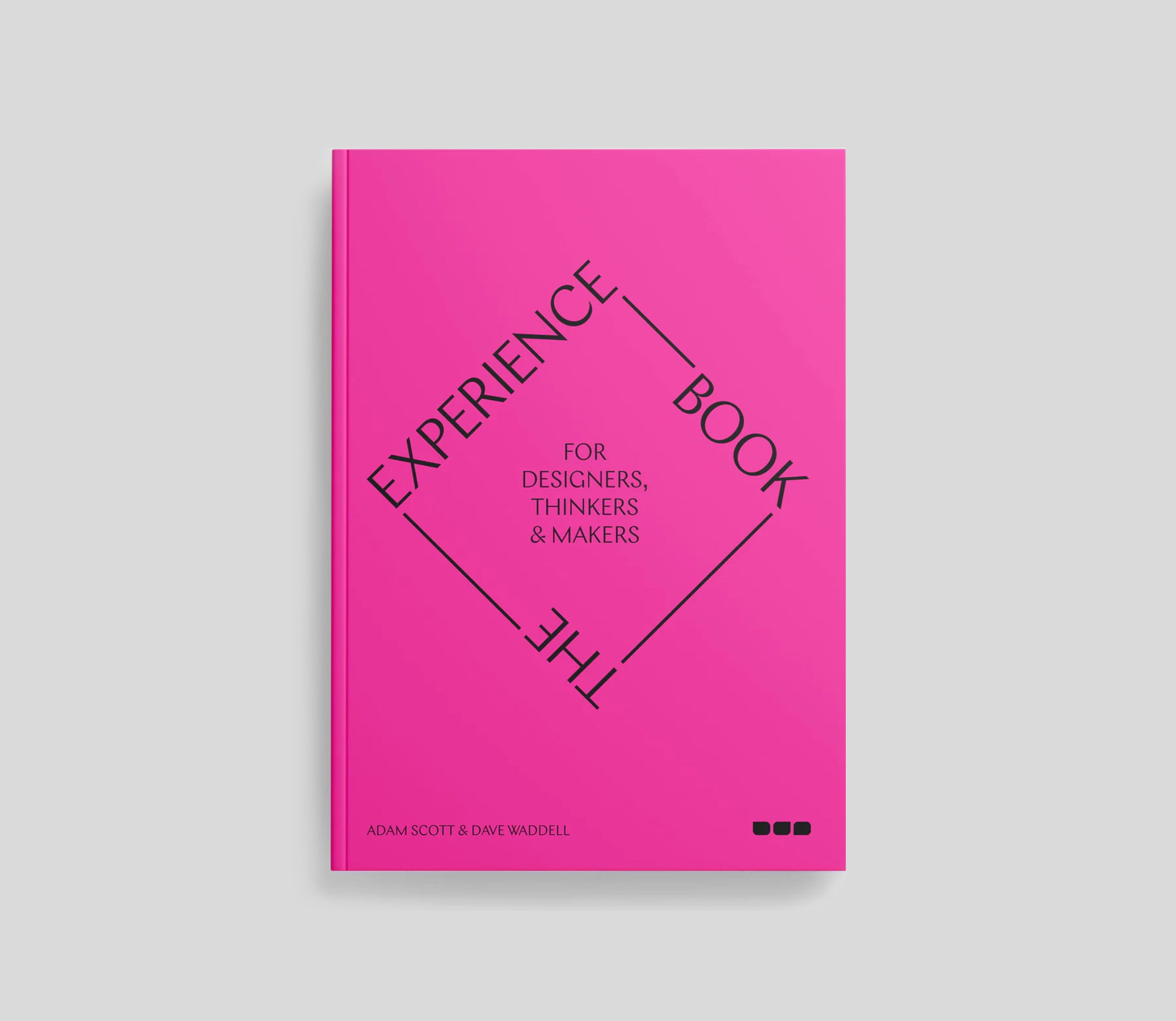 Pink book titled 'The Experience Book for Designers, Thinkers & Makers' by Adam Scott and Dave Waddell, featuring black text and graphic elements on the cover.