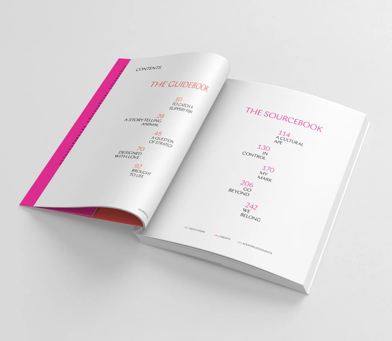 Open book with colorful contents pages displaying two sections: The Guidebook and The Sourcebook, listing chapter titles and page numbers in pink and black text on a white background.