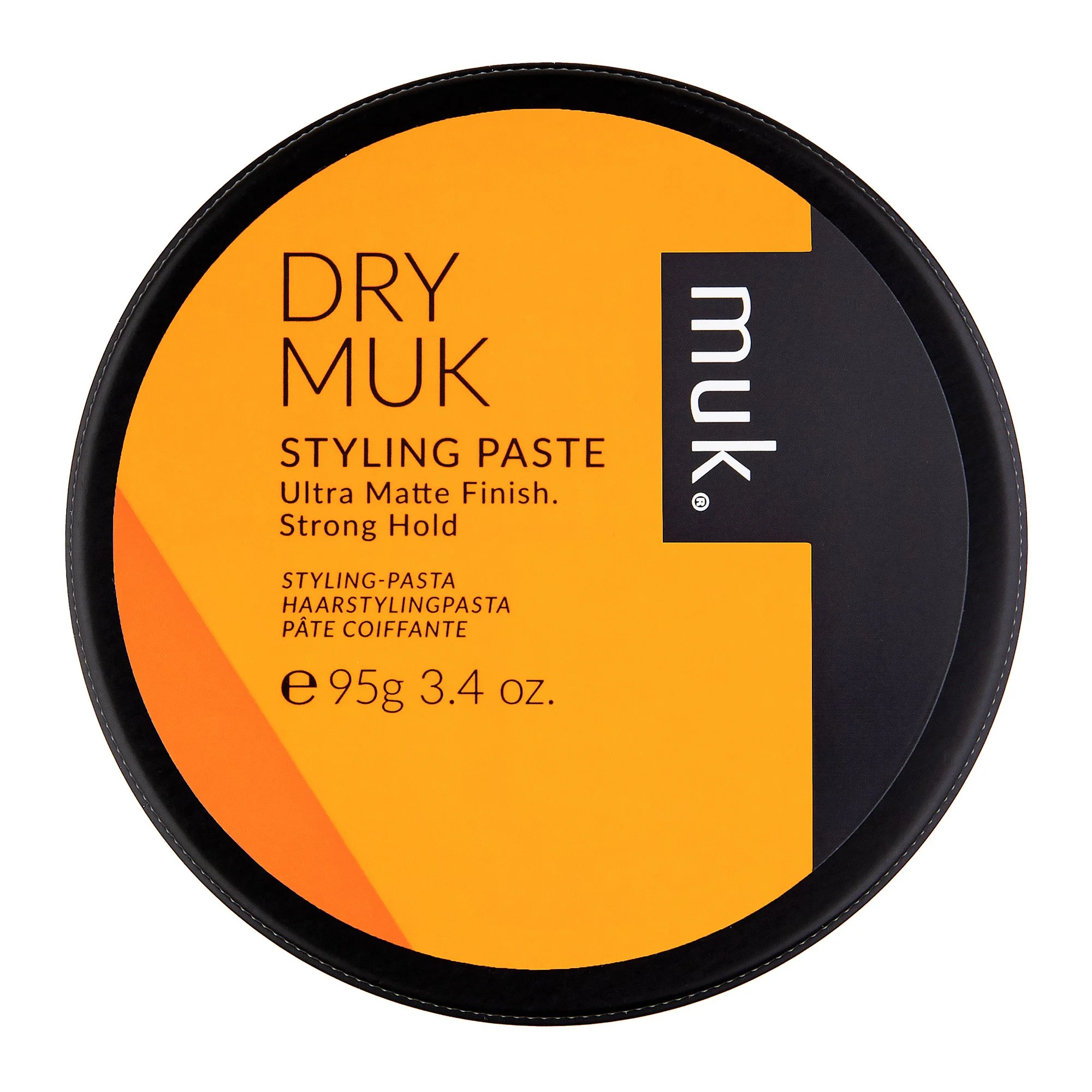 A round container of MUK Dry Muk Styling Paste with an orange label, describing low sheen and brutal hold.