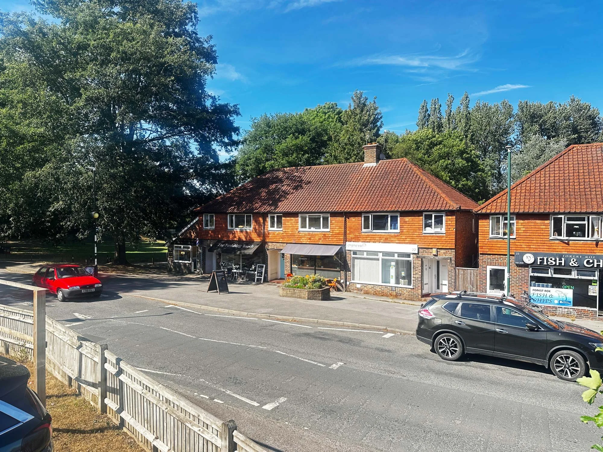 Semi-detached suburban red-brick homes with midcentury features, bay windows, and private driveways.