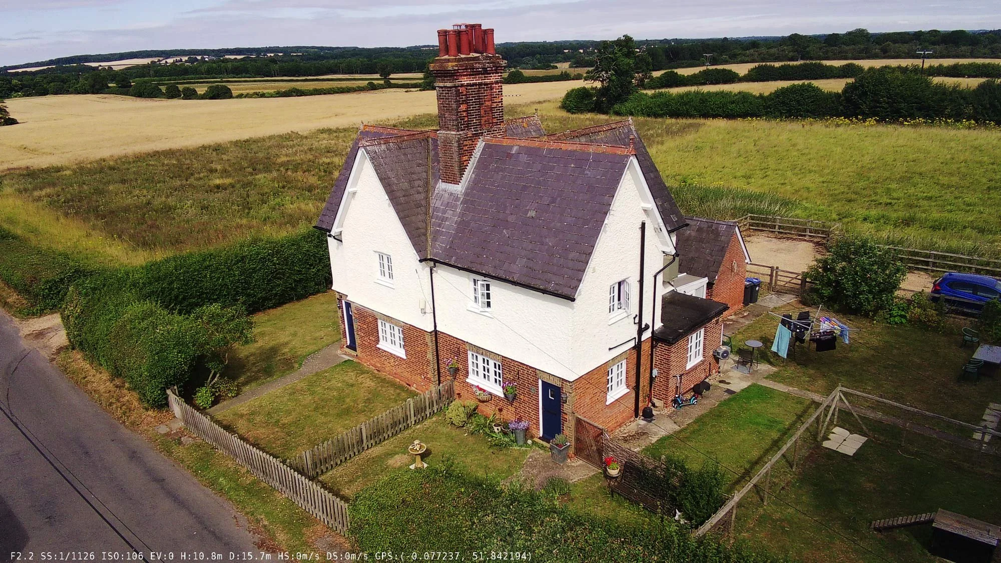 Aerial photograph of a Tudor-style two-storey cottage with steep gabled roof and red brick chimney