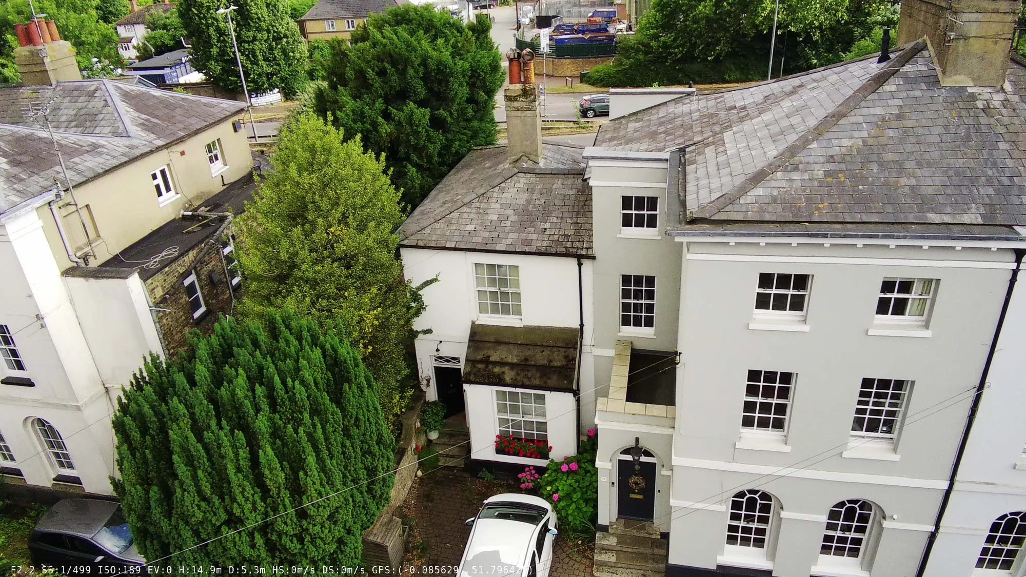 Overhead view of a Regency-era white stucco townhouse terrace with tall sash windows and classical proportions.