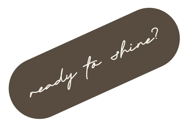 A dark oval-shaped button with white cursive text that says 'ready to shine?'