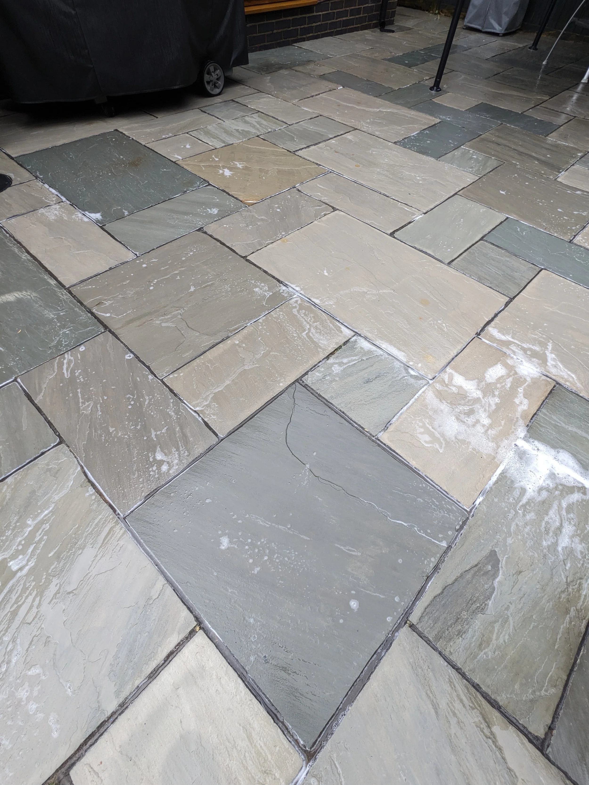 Patio cleaning with pressure washing on stone surface