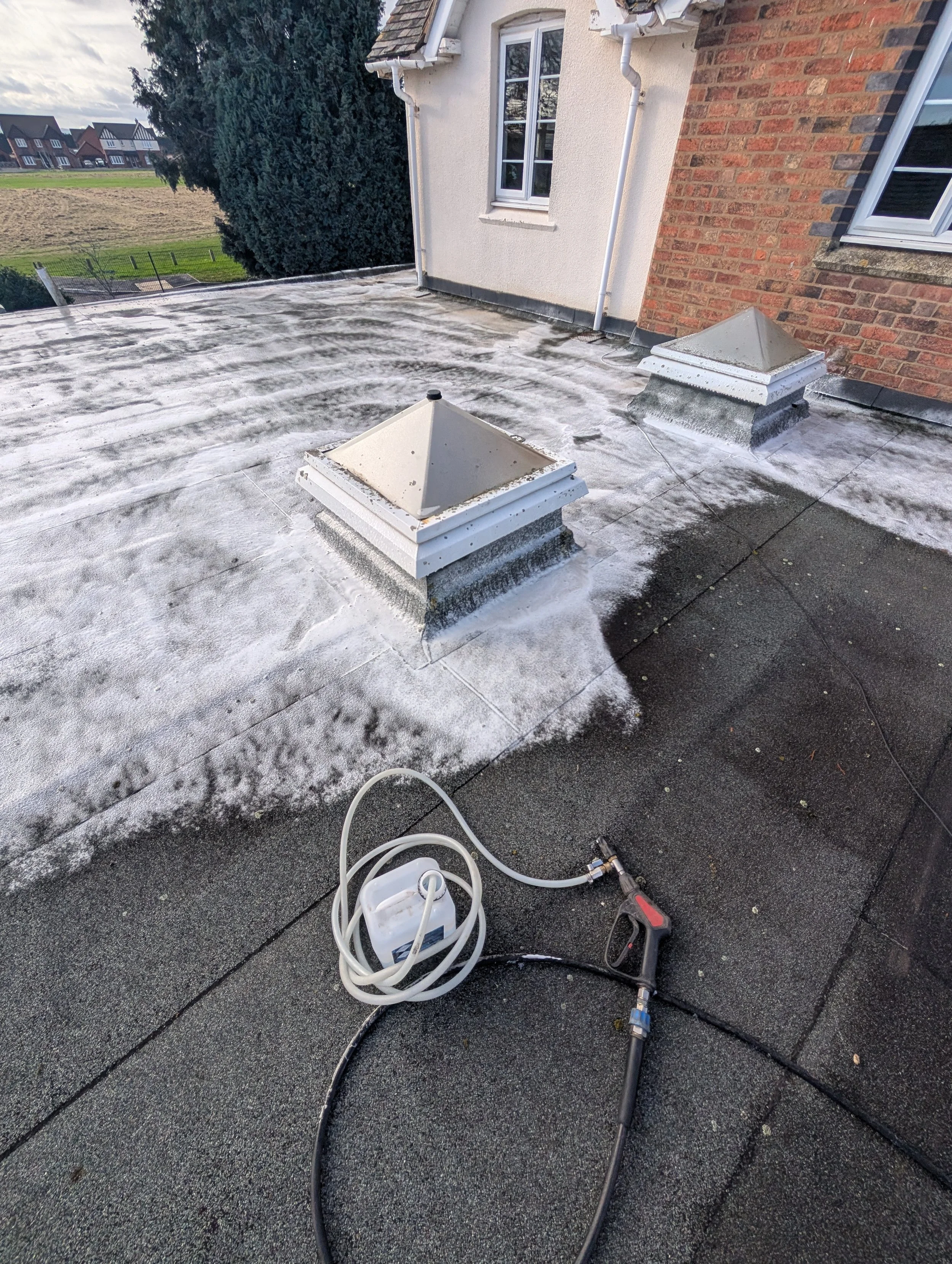 Exterior cleaning equipment in use on residential property