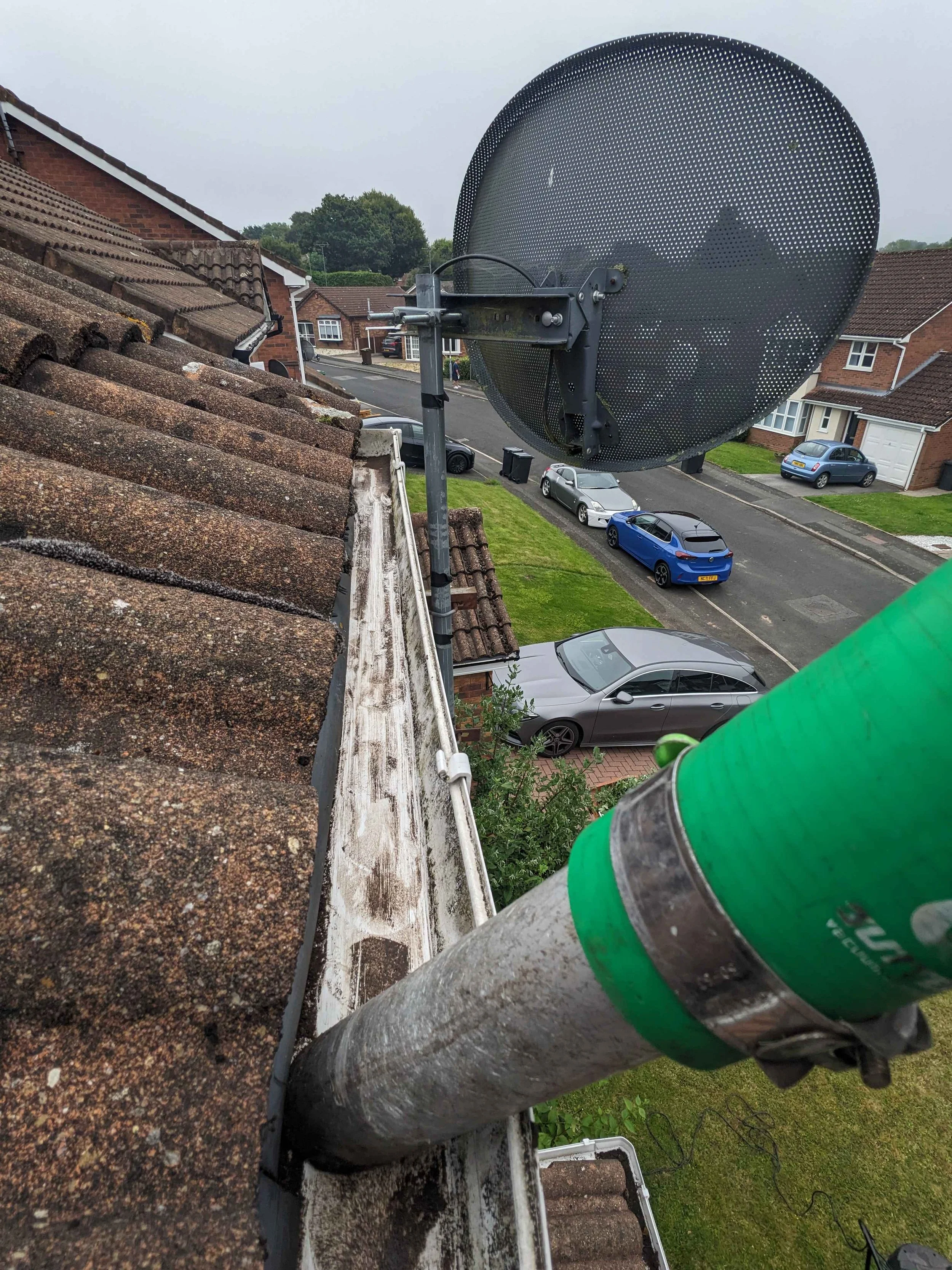Gutter cleaning removing leaves and debris from roof