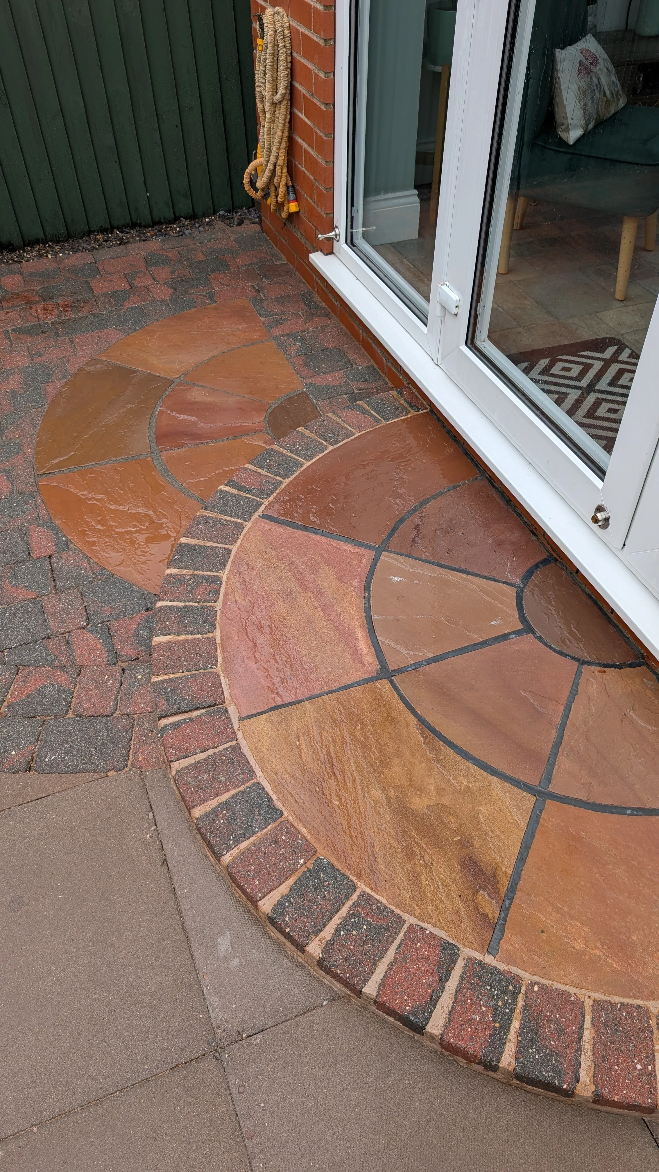 Patio cleaning with pressure washing on stone surface