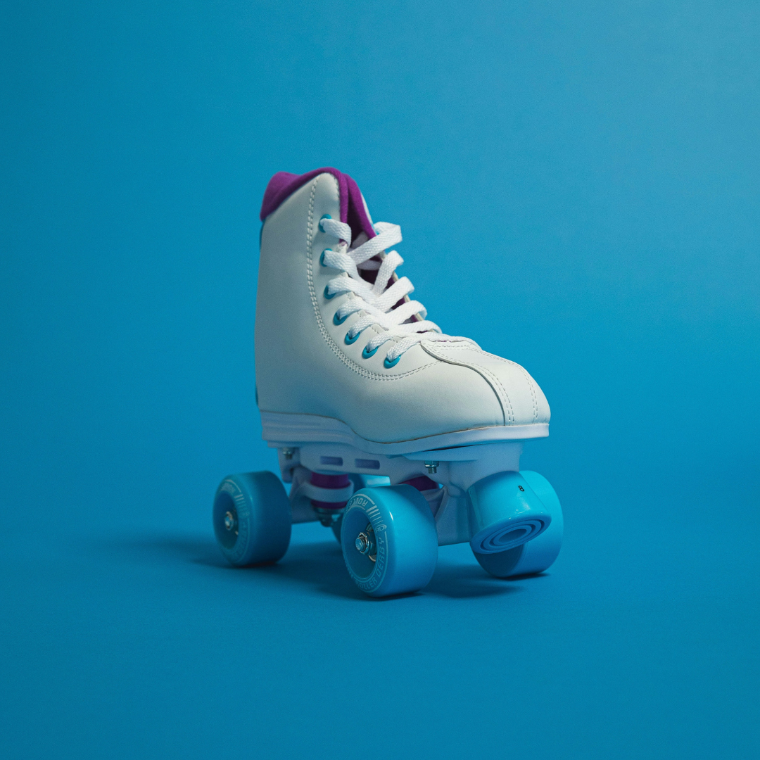 Photo of a white roller boot with turquoise wheels and stopper to represent Rebecca