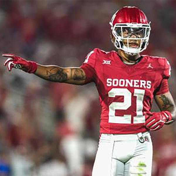 An American football player in a red uniform with the number 21 and