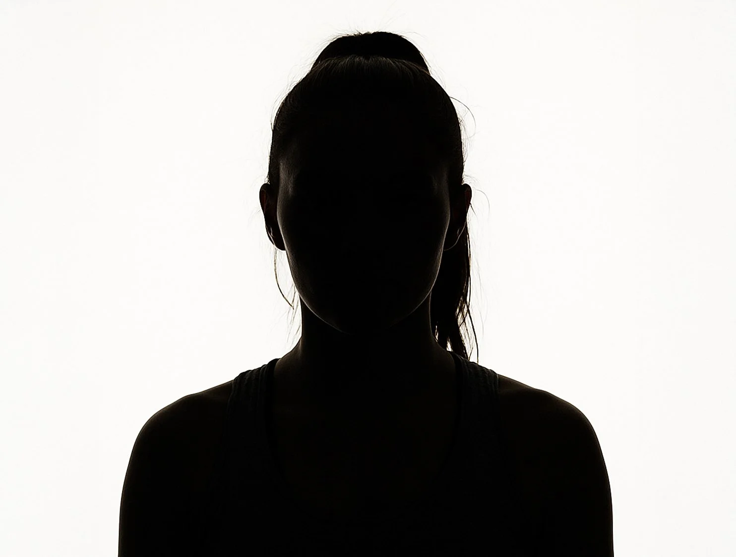 Silhouette of a woman with her hair tied back, against a white background.