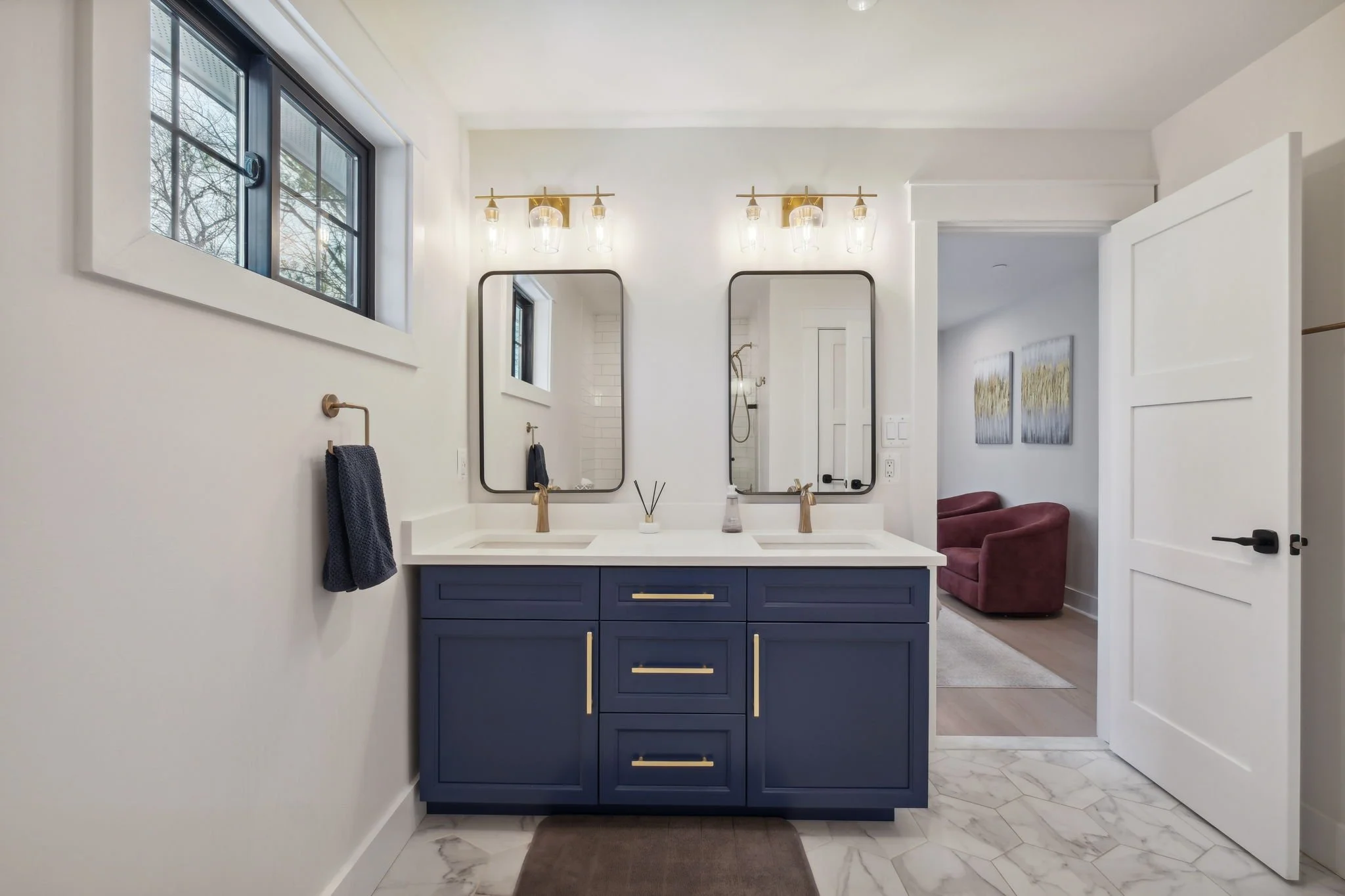 Bathroom with blue cabinets, dual vanity