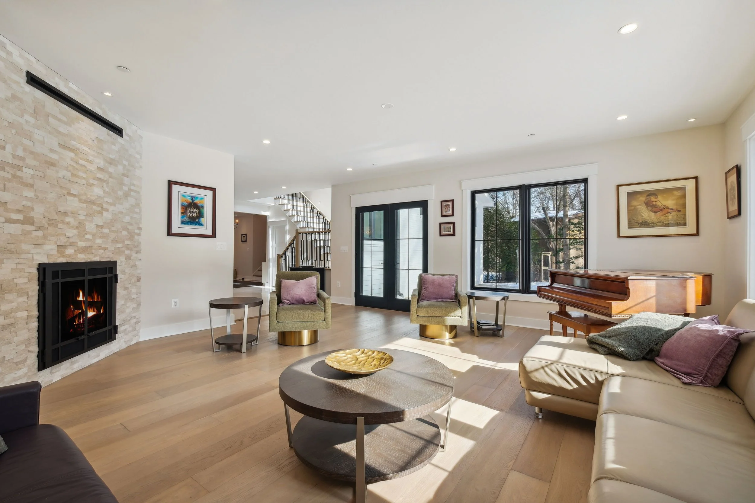 Formal Living Room with Warm tones including gold bases darker woods and Fireplace Feature