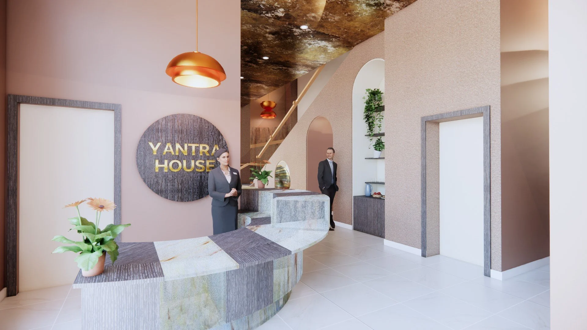 Reception area of Yantra House with two staff members in business attire, a woman at the front desk and a man in the background, beige and gray decor, plants, modern lighting, and a textured wall.
