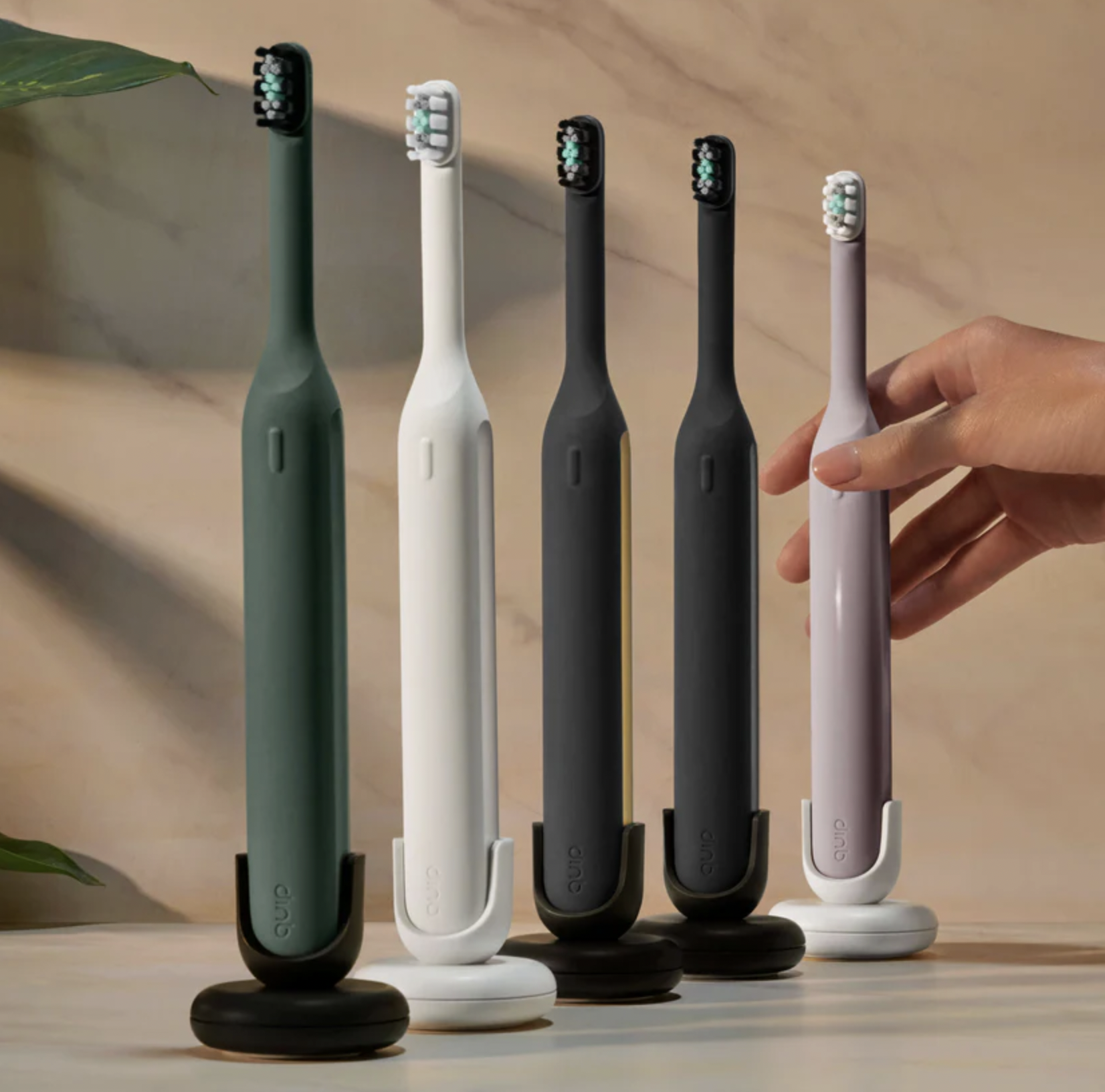 Electric toothbrush and travel case on a striped surface