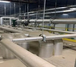 Industrial pipes and ducts in a factory or plant setting.