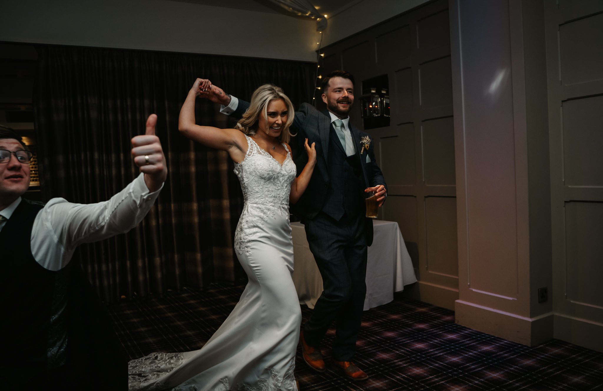 Bride and groom dancing and celebrating at their wedding reception.