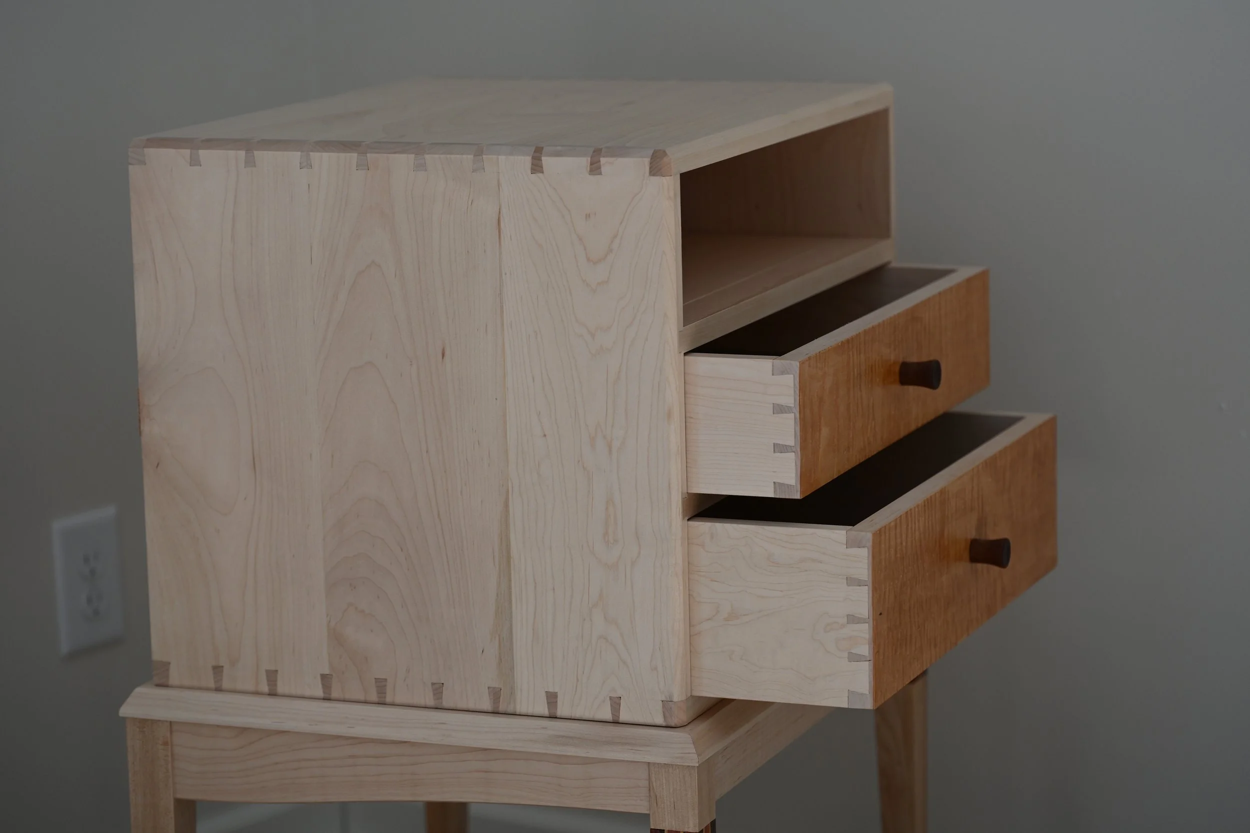 nightstand with two open drawers, made with hand cut dovetail joints.