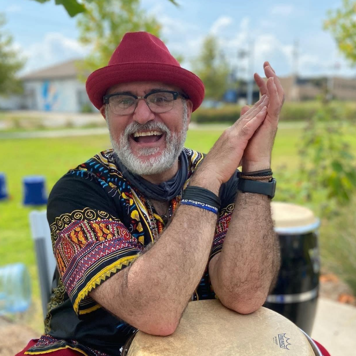Al "Papa Rap" Lopez smiling with his elbows on a drum