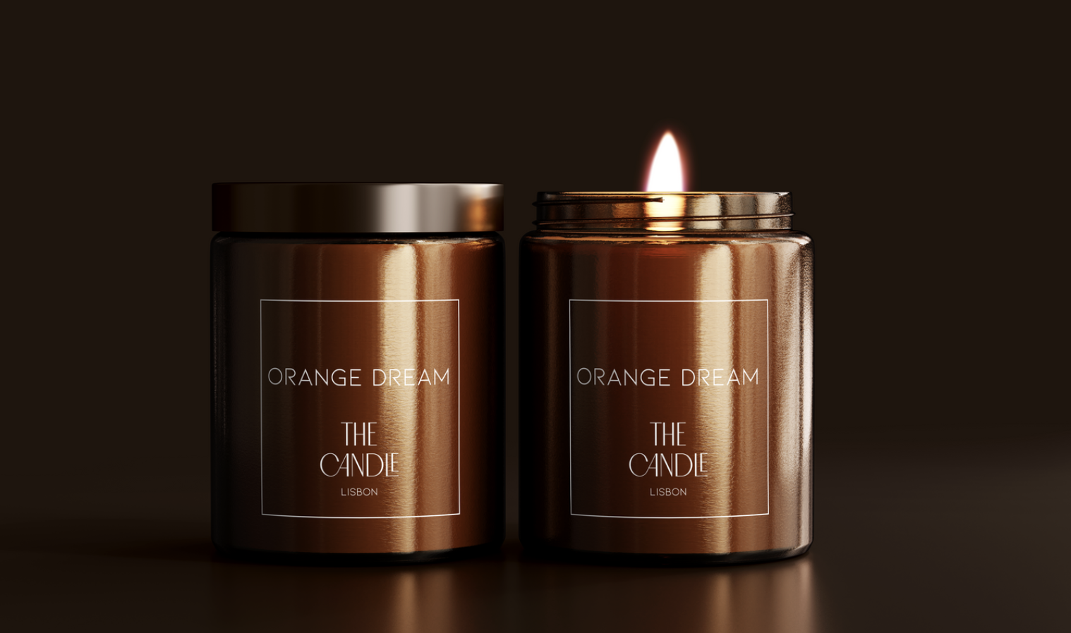 Two copper-colored candles in jars, one with a flame, labeled 'Orange Dream' by 'The Candle Lisbon', set against a dark background.