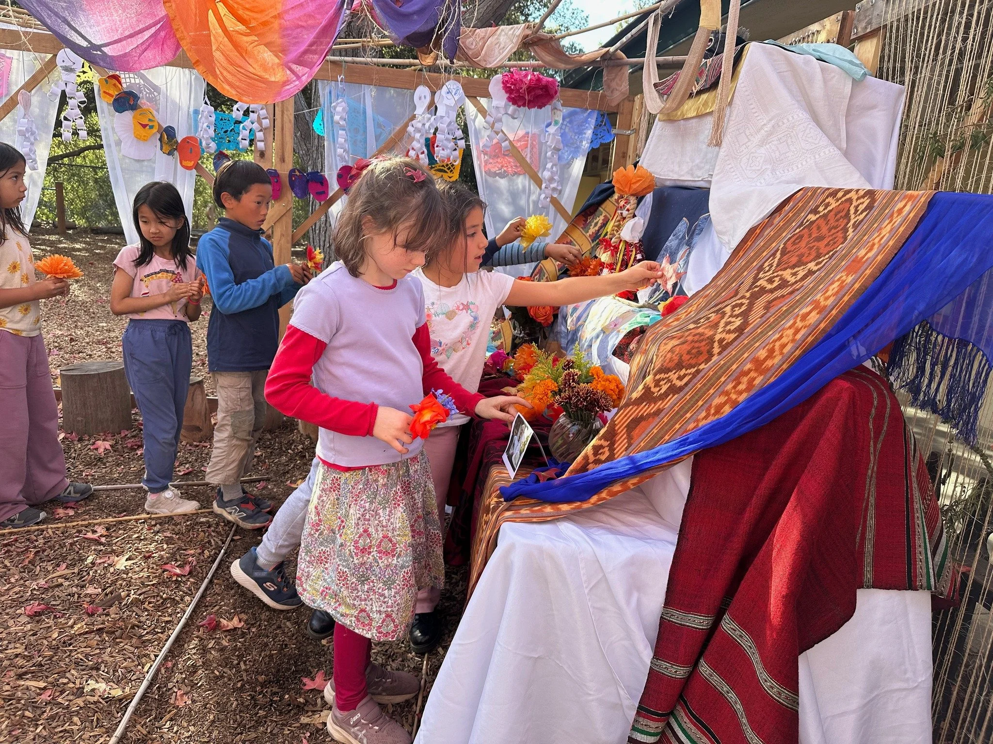 Yesterday, our Los Altos campus came together to honor D&iacute;a de los Muertos before a beautiful altar created by our fourth-grade students. We sang, heard a story, and shared horchata and pan de muerto in celebration of memory, connection, and th