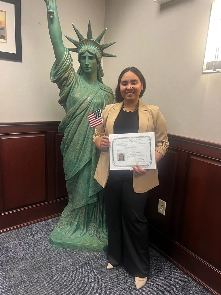 woman earning her citizenship with the statue of liberty