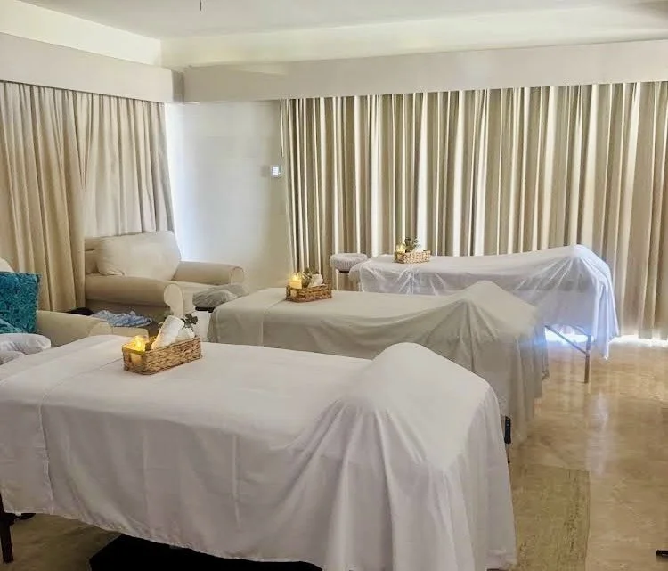 Group massage setup with multiple professional massage tables in a villa