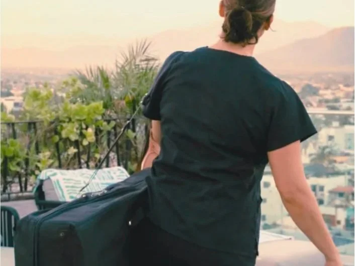 Mobile massage therapist carrying equipment to a guest accommodation