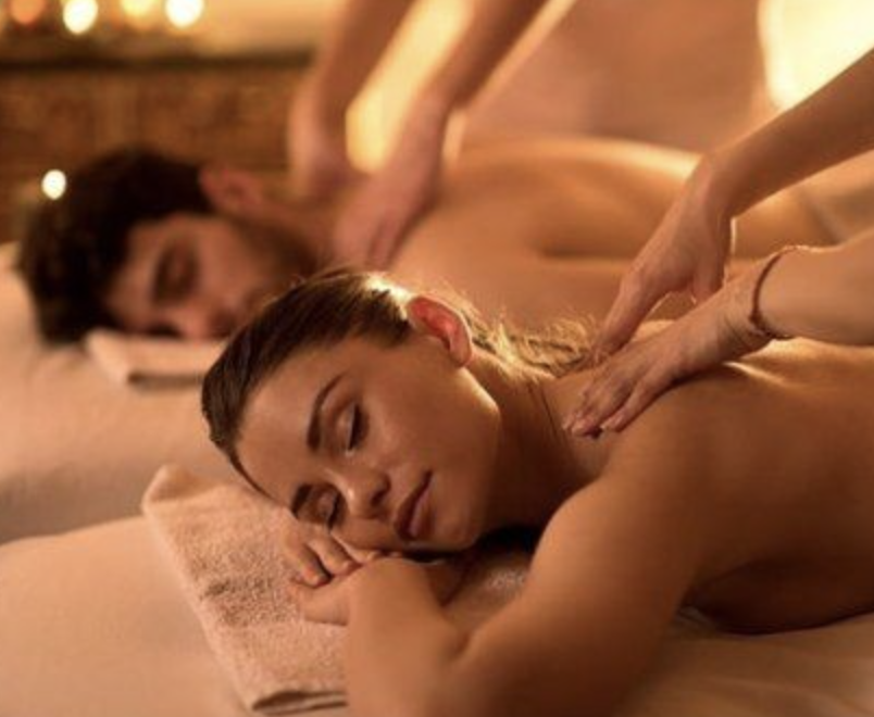 Couples massage with two therapists providing simultaneous treatments