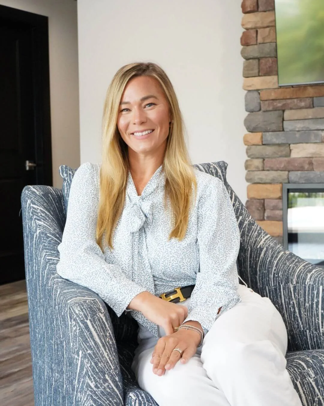 Young Female Entrepreneur, Interior Designer wearing professional yet stylish white dress with ruffles