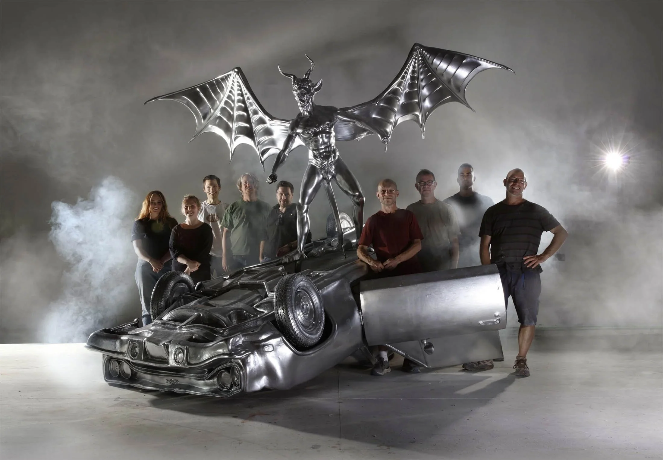 Windsor workshop team members photographed by Venn Portraits in front of an amazing prop they manufactured for Black Sabbath the ballet.