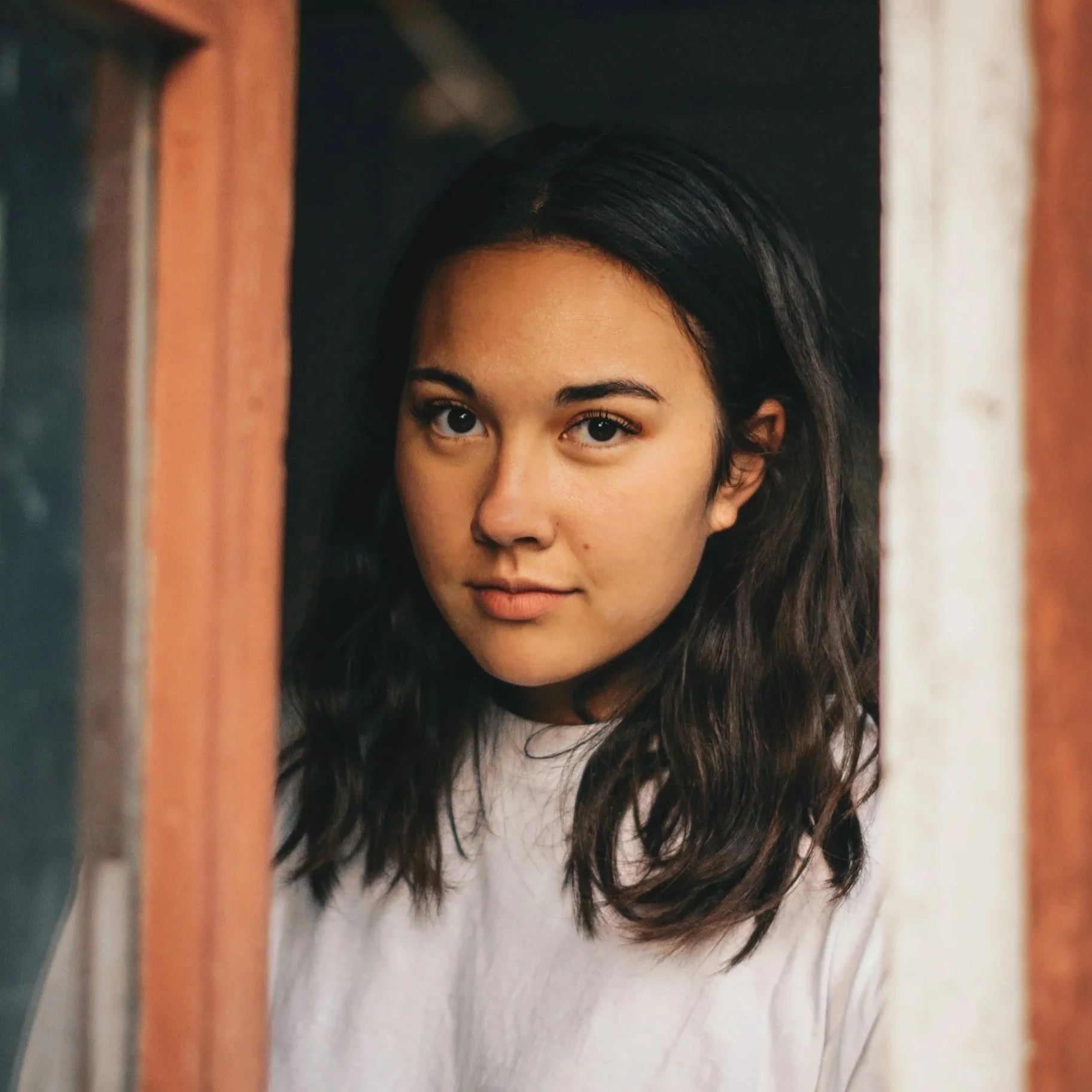 Woman at a door, navigating anxiety and life transitions in her late 20s