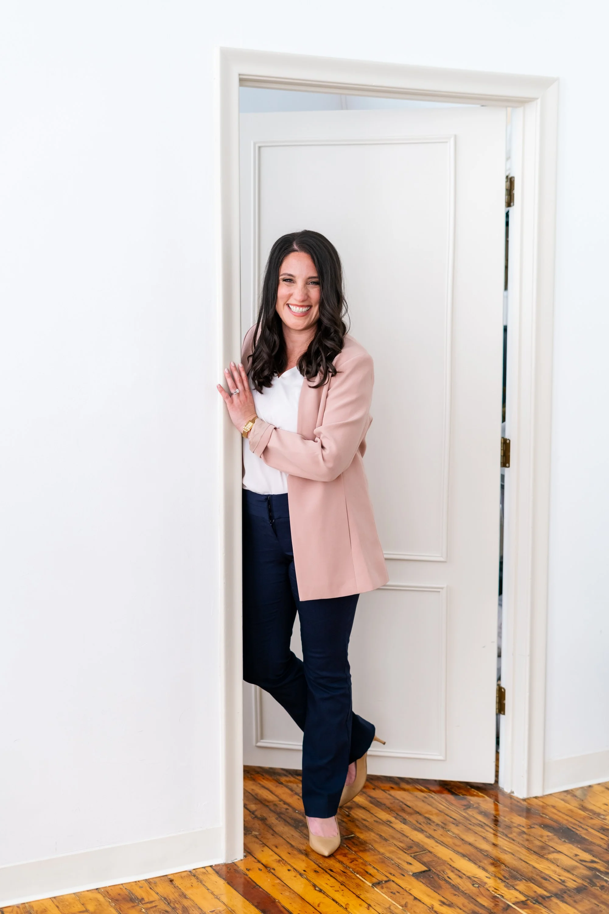 Dayna DiBiasi, LCSW Founder of EleVolve therapist greeting her client at the door