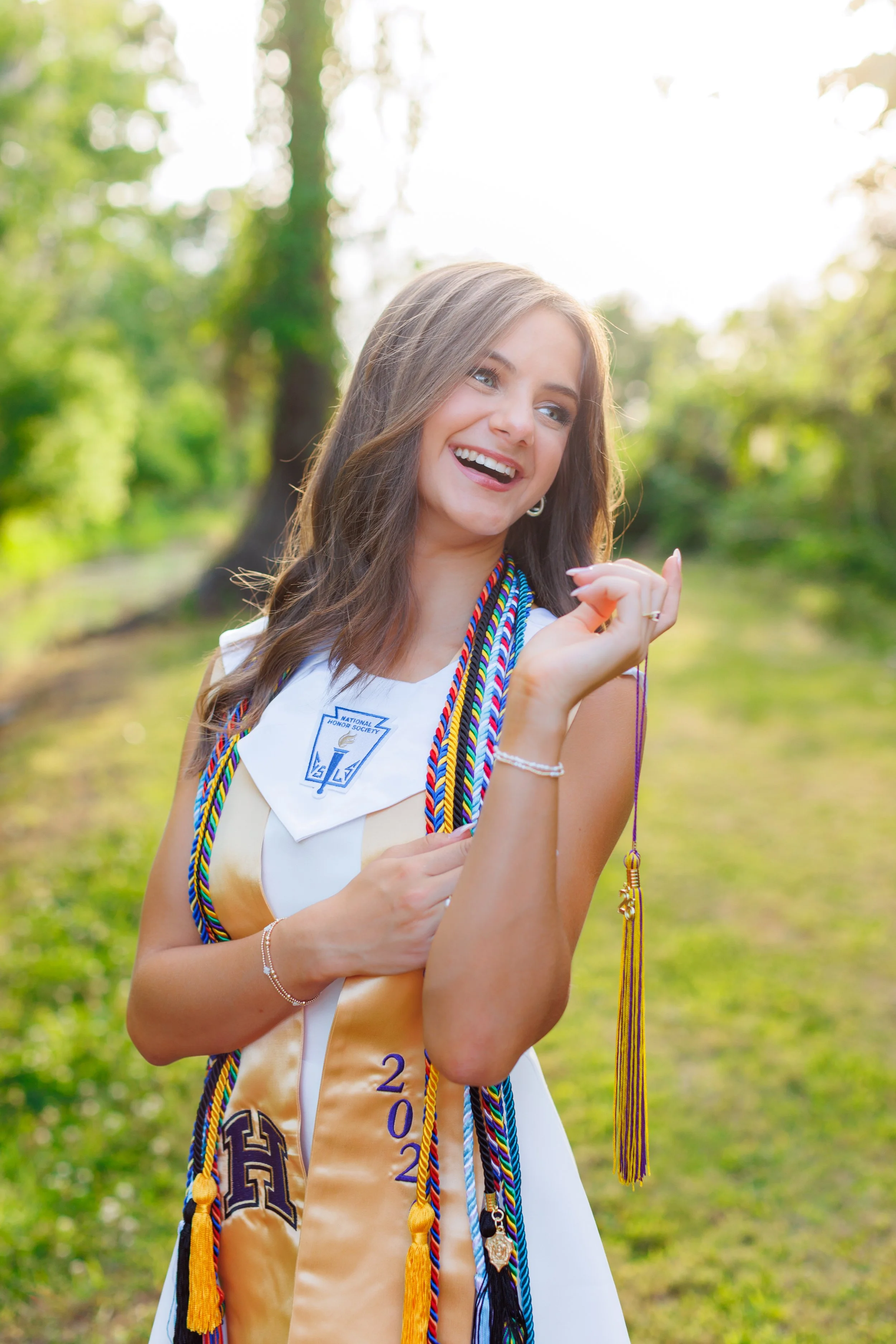 high school senior cap and gown session outdoors during golden hour