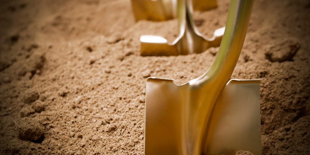 gold shovels in dirt