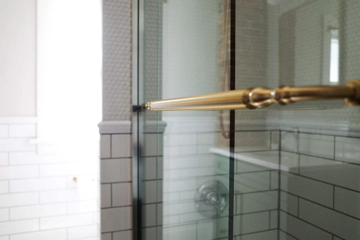 From snow to steam 🧖🏻&zwj;♀️
➖➖➖➖➖➖➖
This historic bathroom wasn&rsquo;t ready to let go of its subway tile so we accessorized with chair rail for a touch of elegance and penny tile for texture. The variety of tiles in this historic bathroom makes 