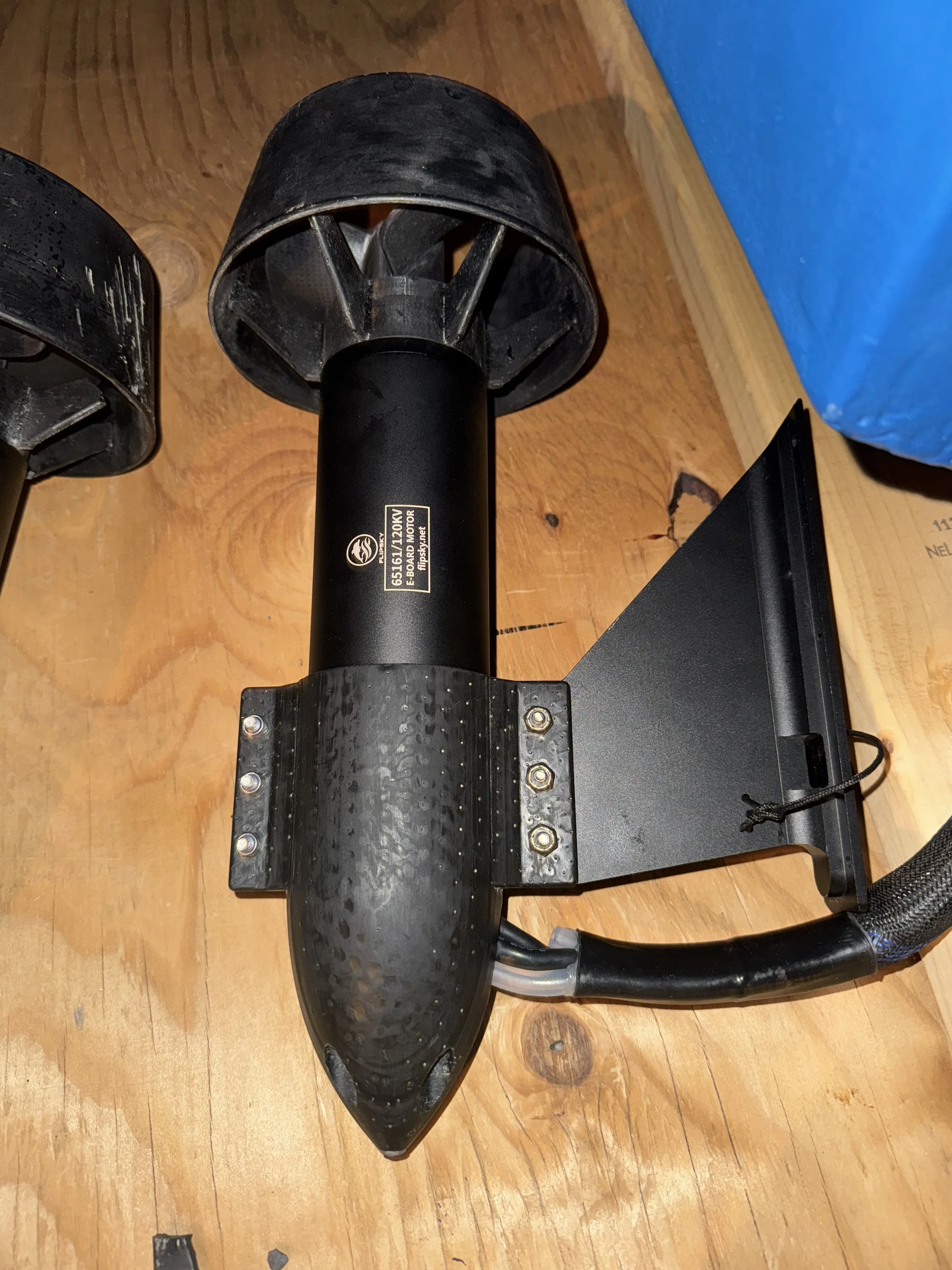 A jet propulsion device mounted on a wooden surface.