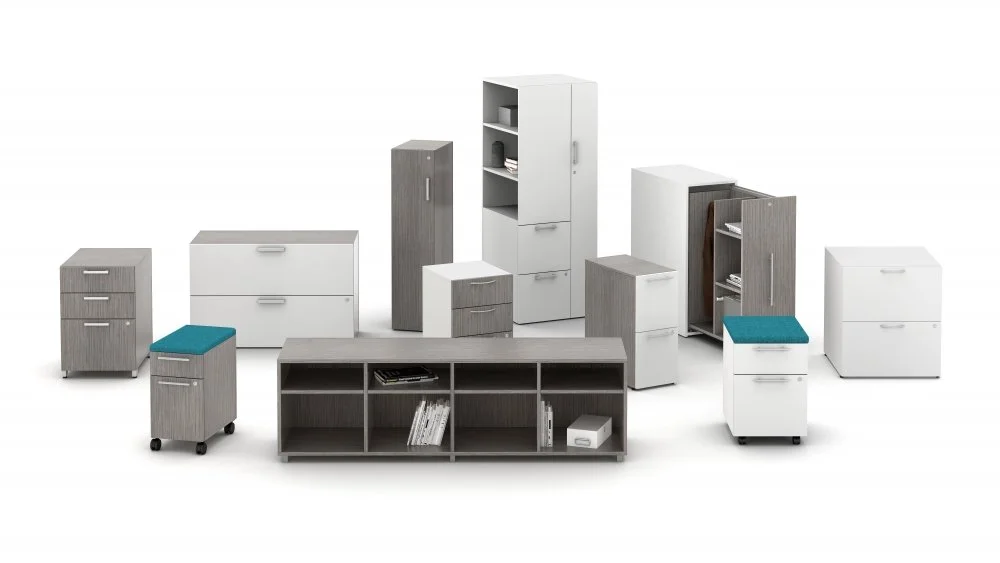 Collection of modern office furniture including cabinets, cabinets with drawers, and storage units in gray and white with some with blue cushions.