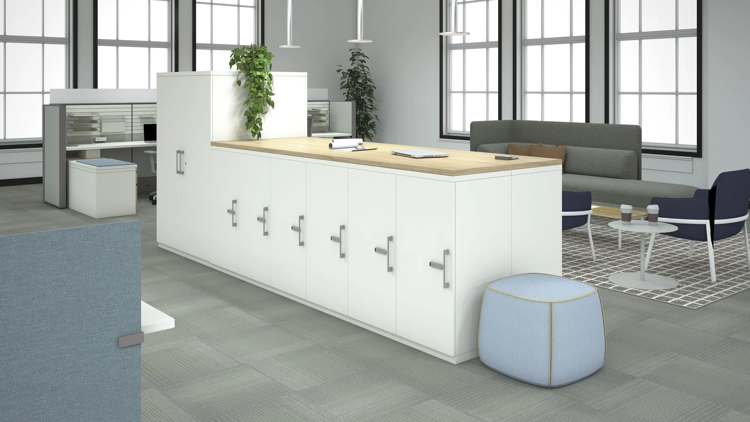 Modern office lounge with a white cabinet and wooden counter, seating area with a gray sofa, blue chairs, a small table with coffee cups, and large windowed walls.